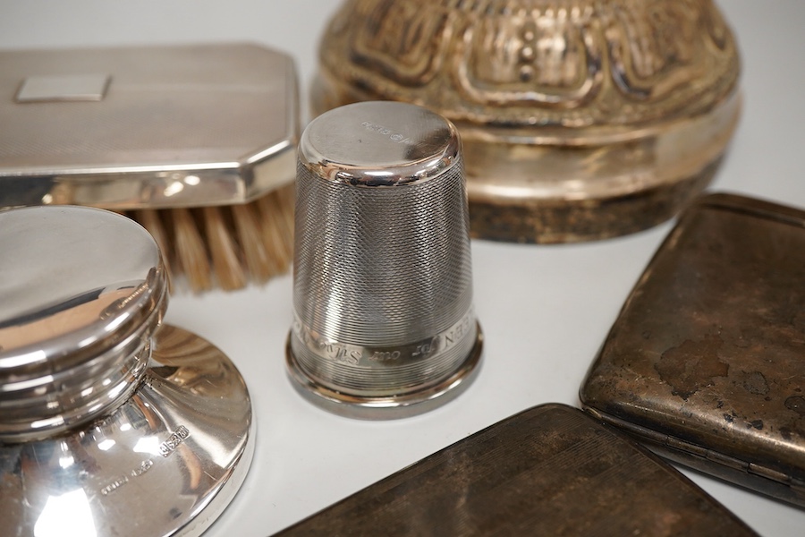 A George V silver top opening cigarette case, Birmingham, 1923, 83mm, together with a silver mounted hair brush, one other silver cigarette case, a silver mounted cigar cutter, a silver mounted inkwell, a large silver th